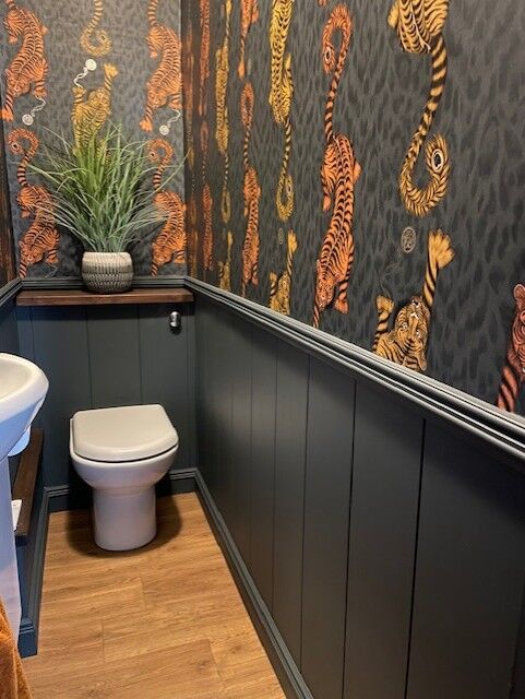 Bathroom with wall panelling and tiger print wallpaper