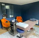 Shiplap wall panelling in a salon painted blue