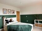 Green bedroom headboard panelling